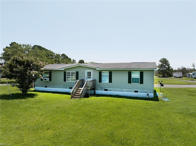 manufactured / mobile home featuring a front lawn