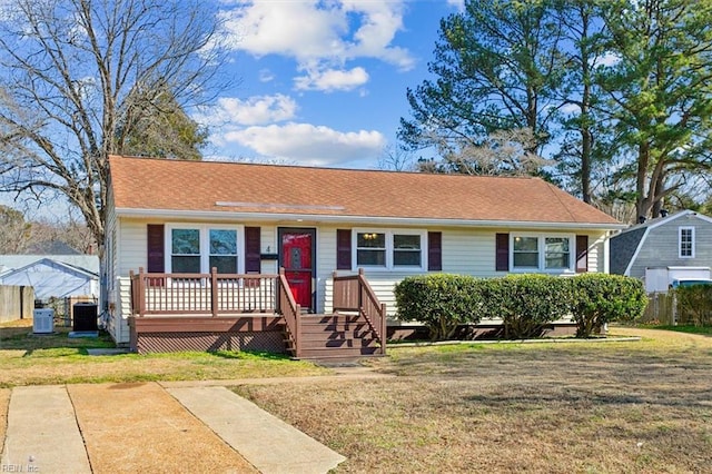 view of front of property with cooling unit and a front lawn