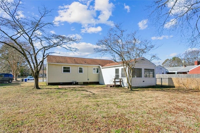 back of property with a lawn