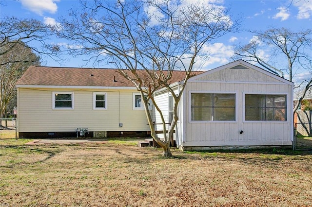 rear view of property with a lawn