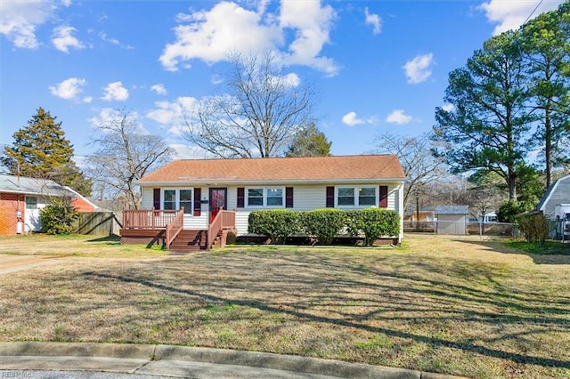 view of front of home with a front yard and a deck