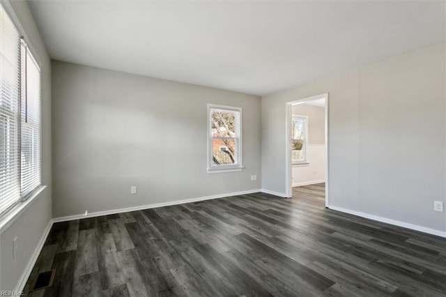 empty room featuring dark hardwood / wood-style flooring