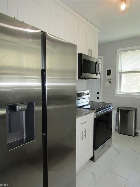 kitchen featuring white cabinetry and appliances with stainless steel finishes