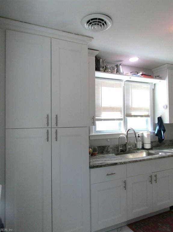 kitchen with sink and white cabinets