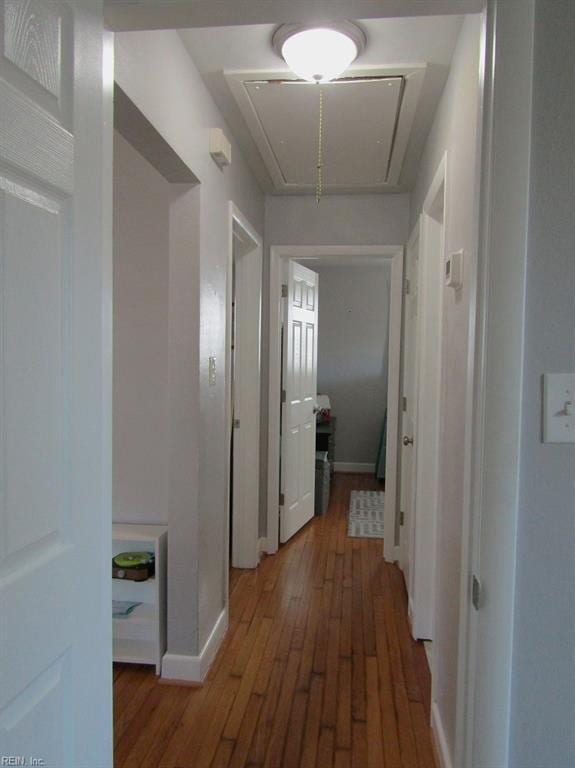 hallway with hardwood / wood-style floors