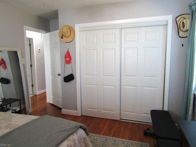 bedroom with a closet and dark hardwood / wood-style floors