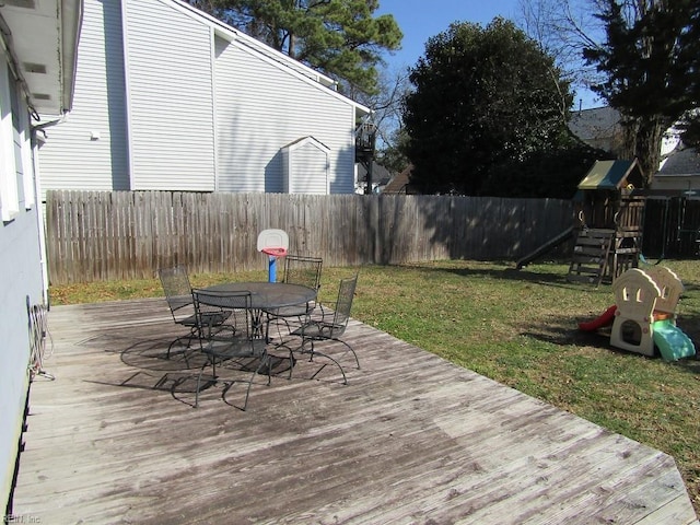 deck featuring a playground and a yard