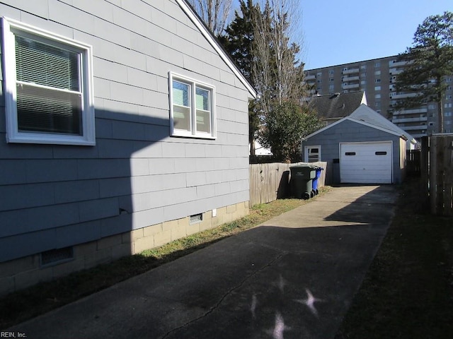 view of side of property featuring a garage and an outdoor structure