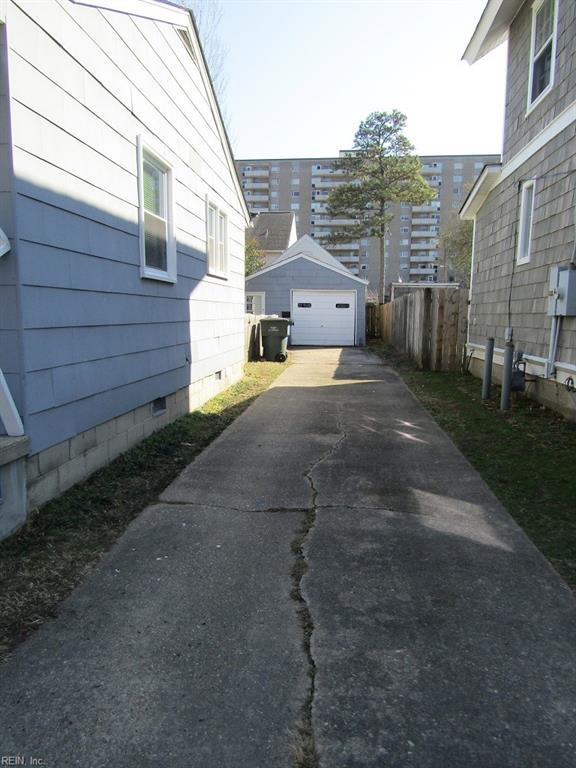 view of side of home with a garage and an outdoor structure