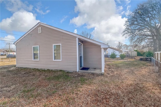 rear view of property with a lawn