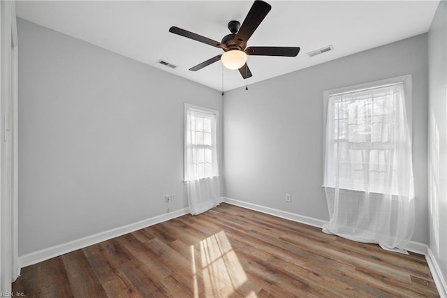 empty room featuring hardwood / wood-style floors and ceiling fan