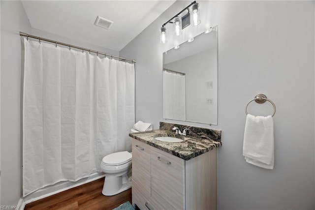 bathroom with vanity, hardwood / wood-style floors, and toilet