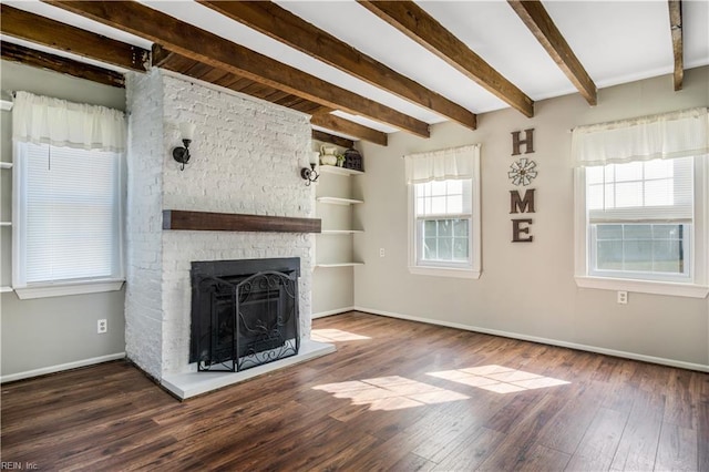 unfurnished living room featuring beamed ceiling, dark hardwood / wood-style flooring, and a fireplace