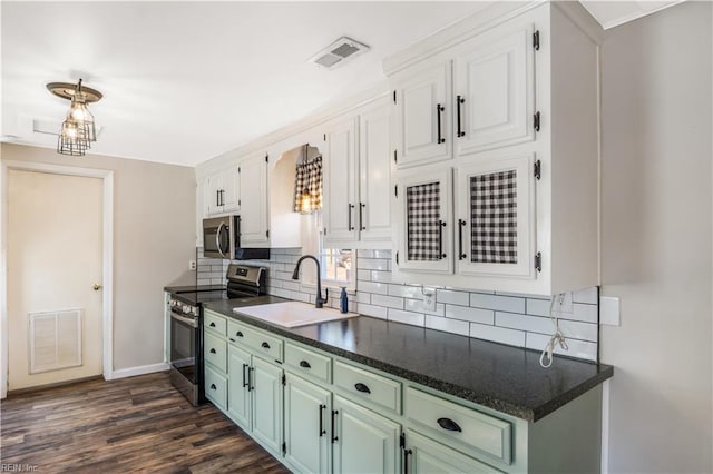 kitchen with white cabinetry, appliances with stainless steel finishes, sink, and decorative backsplash