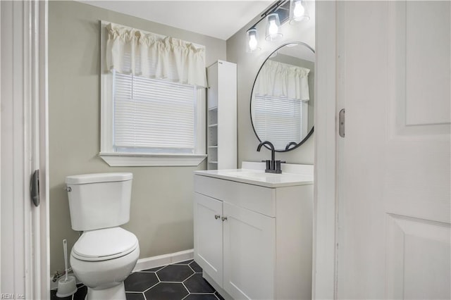 bathroom featuring tile patterned floors, toilet, and vanity