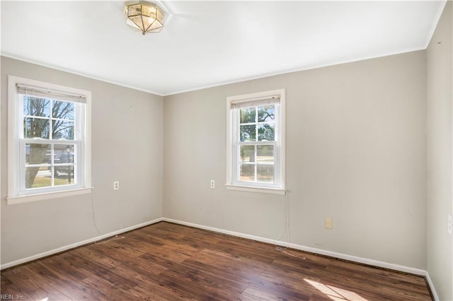 empty room with crown molding and dark hardwood / wood-style flooring