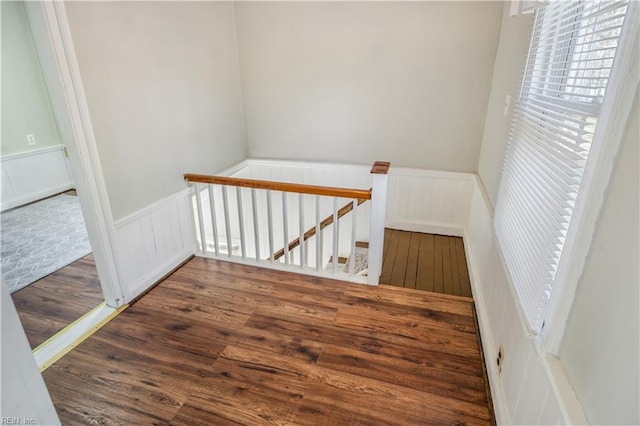 stairs featuring hardwood / wood-style floors