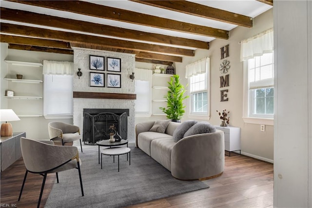 living room featuring beam ceiling, hardwood / wood-style floors, and a fireplace