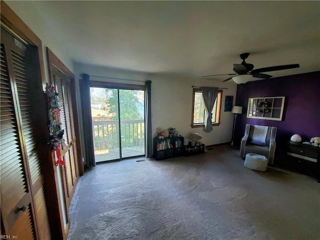 living room featuring carpet flooring and ceiling fan