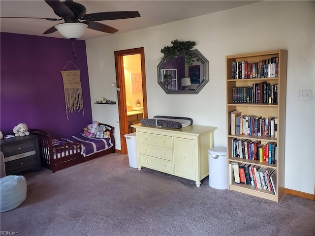 bedroom with dark carpet, ceiling fan, and ensuite bathroom