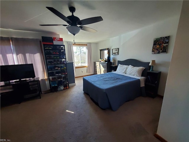 bedroom featuring ceiling fan and carpet