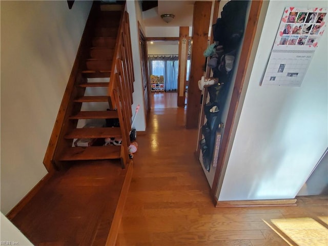 staircase with wood-type flooring