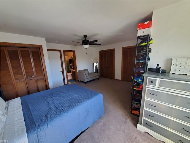 bedroom featuring multiple closets, light colored carpet, and ceiling fan