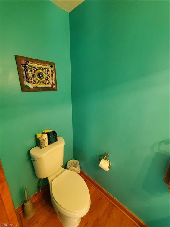 bathroom with wood-type flooring and toilet