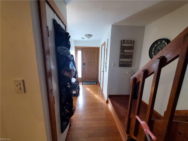 hallway with light hardwood / wood-style floors