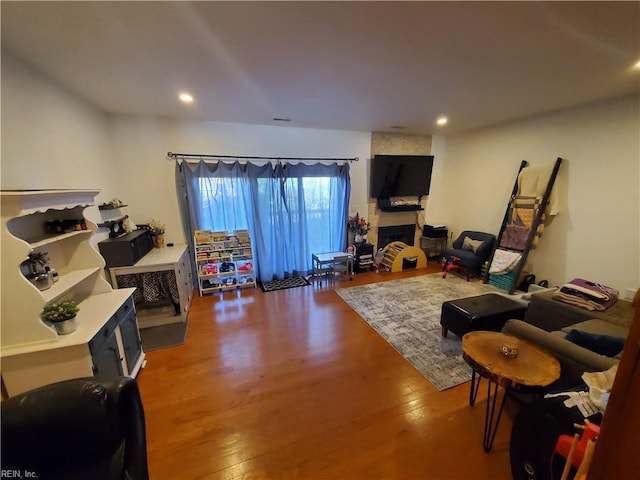 living room featuring hardwood / wood-style flooring and a fireplace