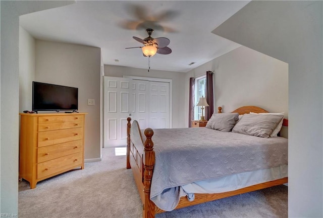 bedroom with carpet, ceiling fan, and a closet