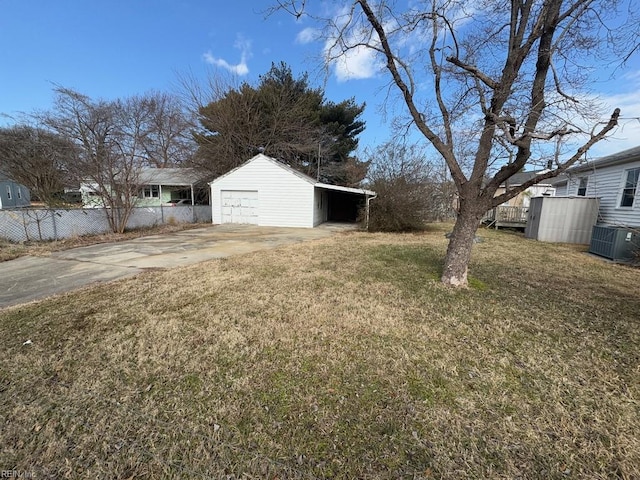 view of yard with a garage, an outbuilding, and cooling unit