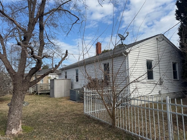 view of home's exterior with a yard and central AC unit