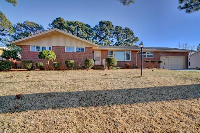 single story home with a garage and a front lawn