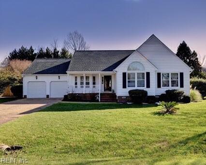 ranch-style home featuring a yard and a garage