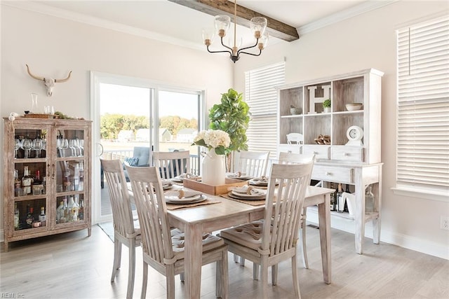 dining area featuring an inviting chandelier, ornamental molding, beam ceiling, and light hardwood / wood-style floors