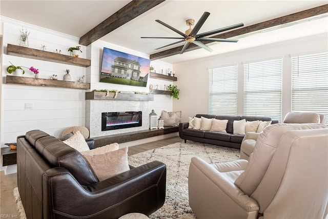 living room with beamed ceiling, ceiling fan, crown molding, and light wood-type flooring