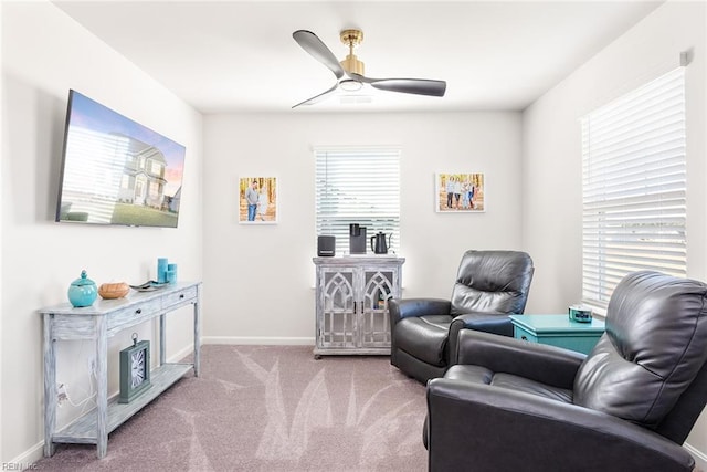 sitting room featuring light carpet and ceiling fan