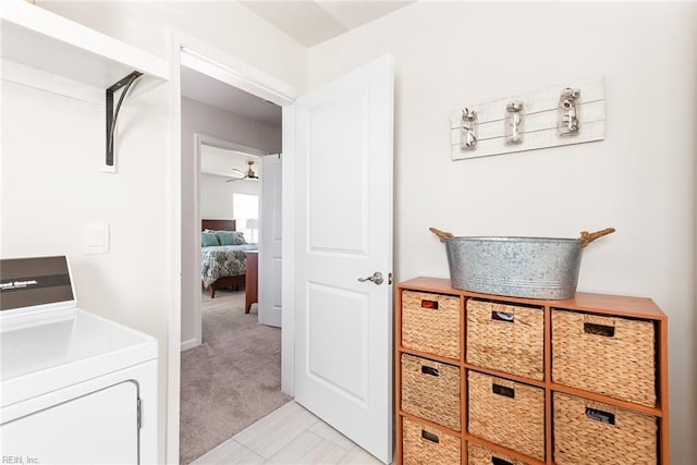 interior space featuring washer / dryer and light colored carpet