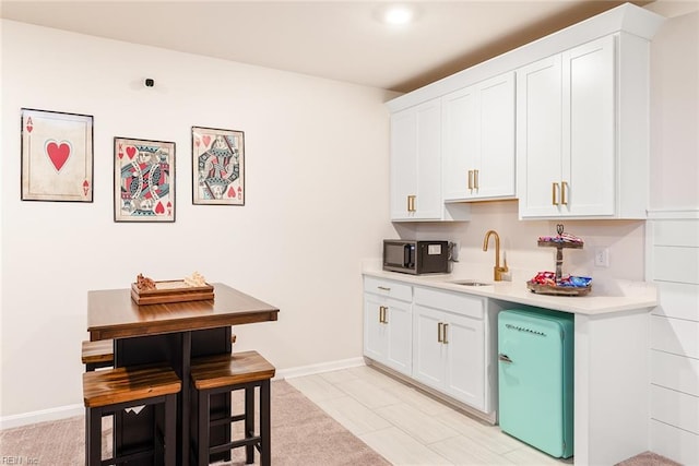 kitchen featuring sink and white cabinets