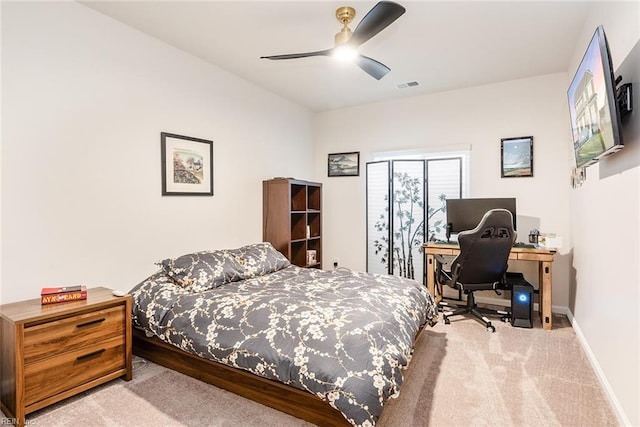 bedroom featuring light colored carpet and ceiling fan