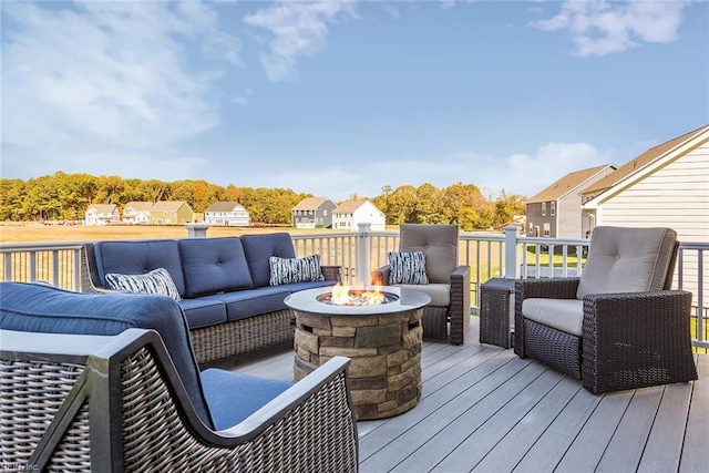 wooden terrace with an outdoor living space with a fire pit