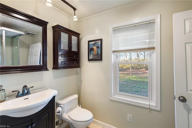 bathroom featuring vanity, crown molding, and toilet