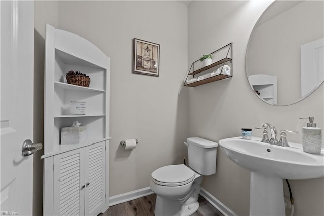 bathroom featuring hardwood / wood-style floors, sink, and toilet