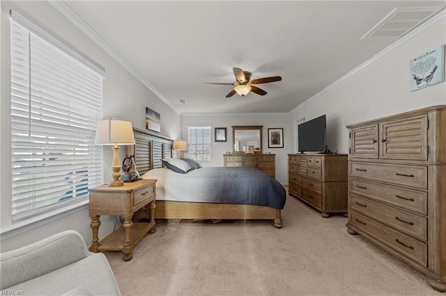 carpeted bedroom featuring crown molding and ceiling fan