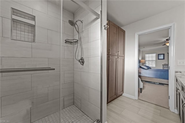 bathroom with an enclosed shower and ceiling fan