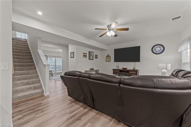 living room featuring ceiling fan and light hardwood / wood-style floors