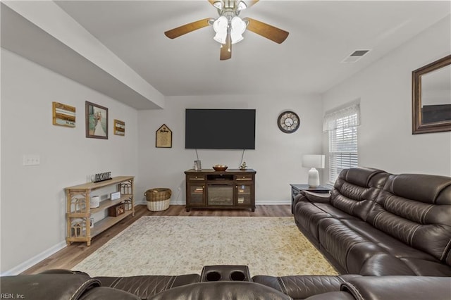 living room featuring hardwood / wood-style flooring and ceiling fan