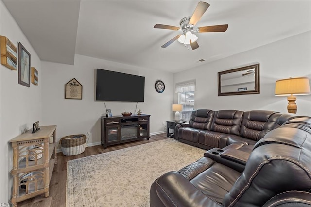 living room featuring dark hardwood / wood-style flooring and ceiling fan