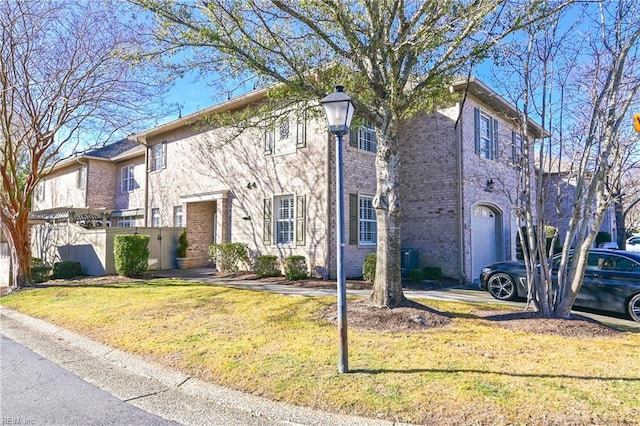 multi unit property with a garage and a front lawn